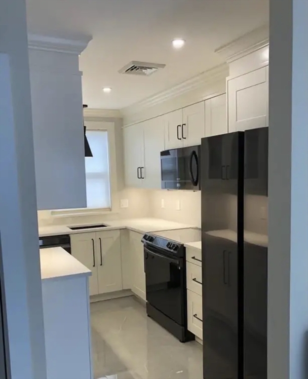 65 Louis Street, Unit A Barnstable, MA 02601 - Photo 7 of 15 a kitchen with stainless steel appliances granite countertop a refrigerator and a sink