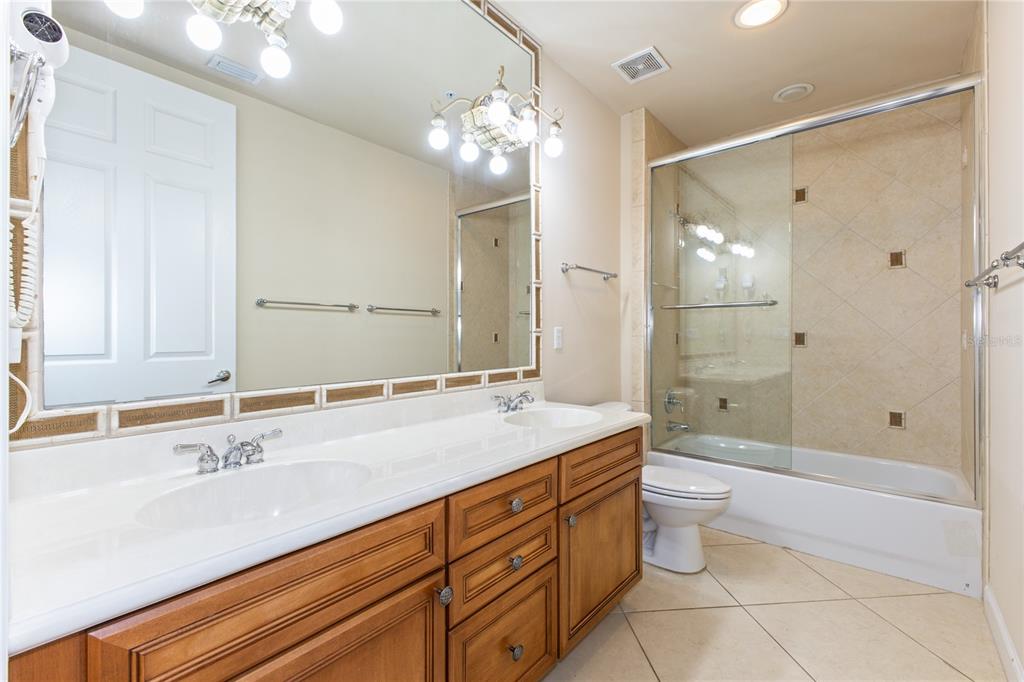 8755 The Esplanade, Unit 126 Orlando, FL 32836 - Photo 12 of 30 a spacious bathroom with a granite countertop sink a toilet a shower and a mirror