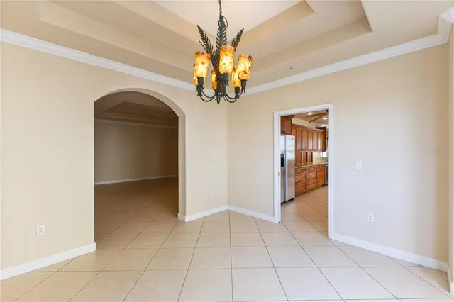 a kitchen with stainless steel appliances kitchen island granite countertop a refrigerator and a sink
