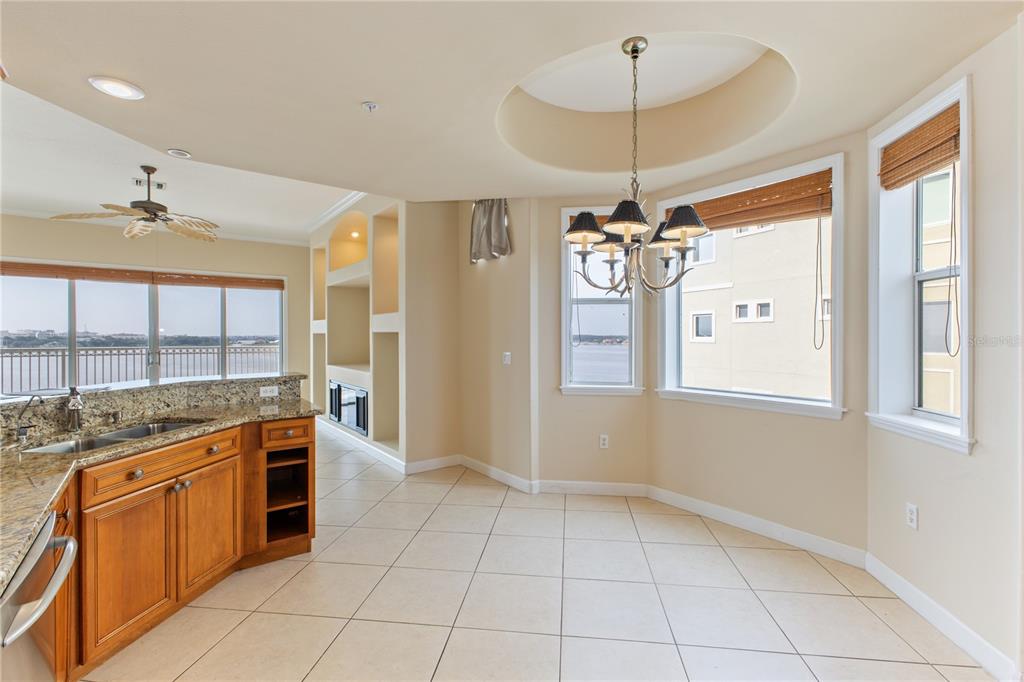 8755 The Esplanade, Unit 126 Orlando, FL 32836 - Photo 16 of 30 a kitchen with stainless steel appliances granite countertop a stove a sink and a refrigerator