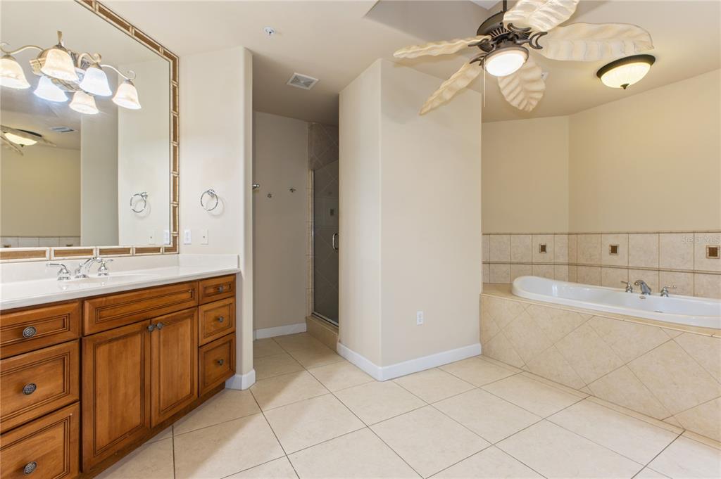8755 The Esplanade, Unit 126 Orlando, FL 32836 - Photo 27 of 30 a spacious bathroom with a double vanity sink mirror and bathtub