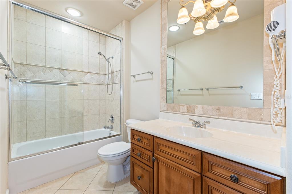8755 The Esplanade, Unit 126 Orlando, FL 32836 - Photo 7 of 30 a bathroom with a sink a toilet and shower