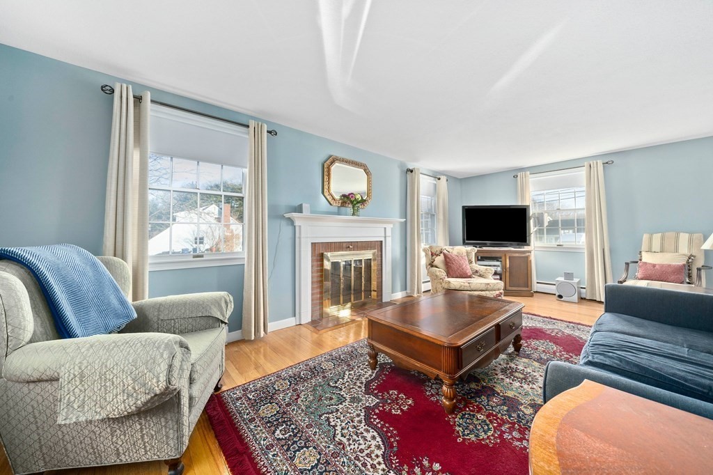 57 Norfolk Road Braintree, MA 02184 - Photo 3 of 30 a living room with furniture and a fireplace