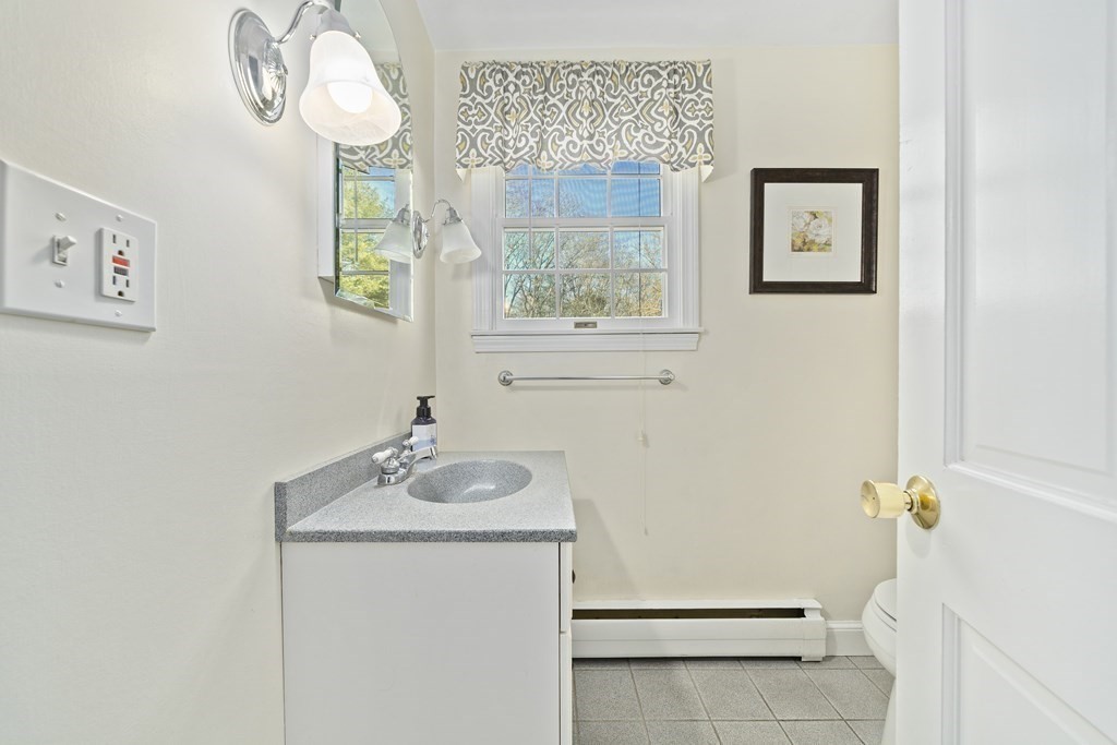 57 Norfolk Road Braintree, MA 02184 - Photo 7 of 30 a bathroom with a sink and a mirror