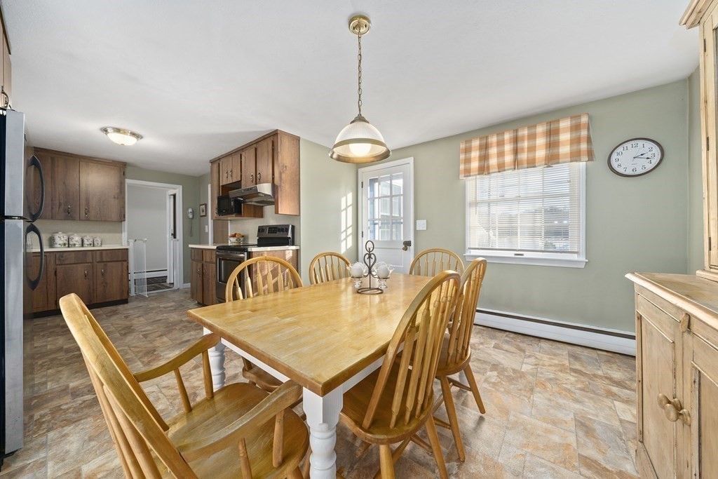 57 Norfolk Road Braintree, MA 02184 - Photo 10 of 30 a dining room with furniture a chandelier and wooden floor