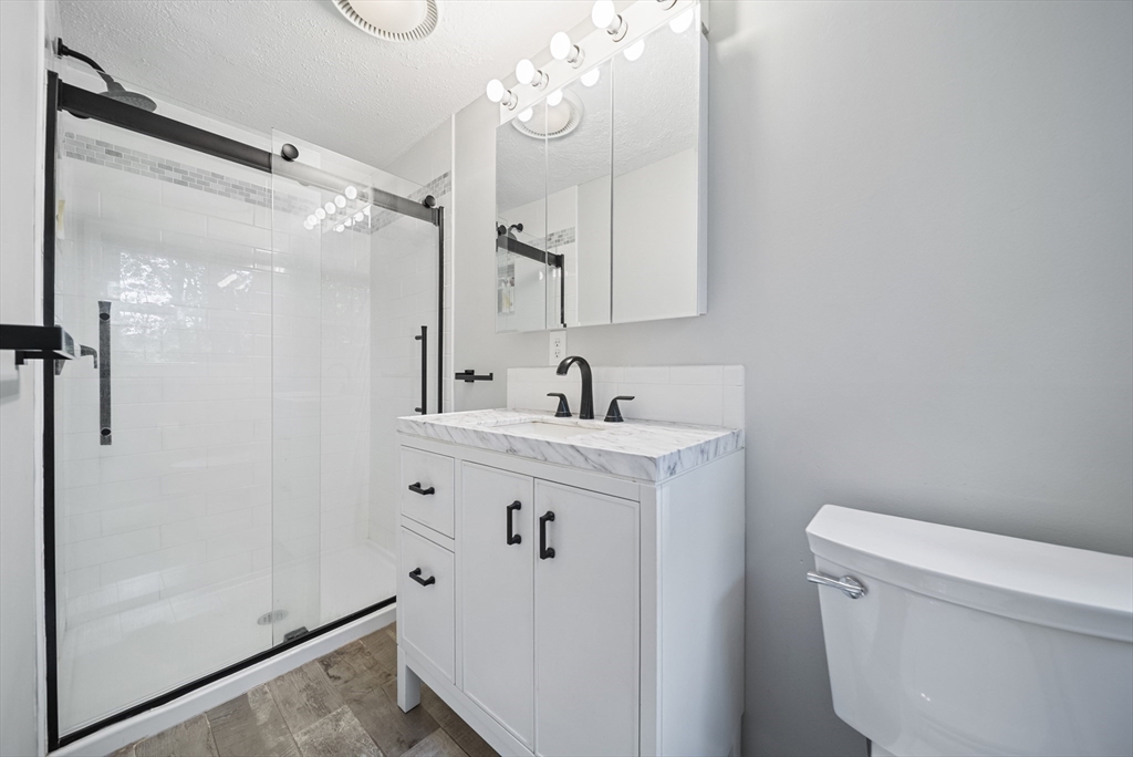 21 Woodman Road Amesbury, MA 01913 - Photo 11 of 30 a bathroom with a sink a toilet and shower