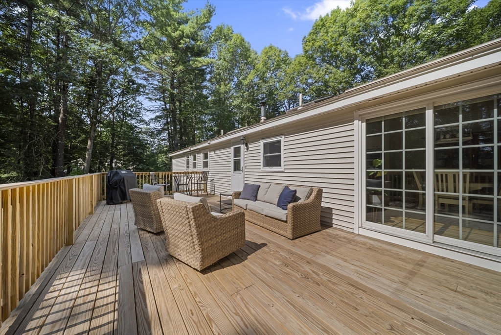 21 Woodman Road Amesbury, MA 01913 - Photo 2 of 30 a view of a deck with couches floor to ceiling window with wooden floor