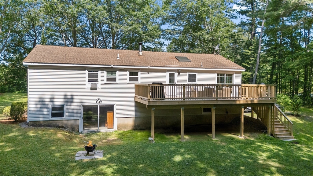 21 Woodman Road Amesbury, MA 01913 - Photo 21 of 30 a view of house with a big yard and large trees