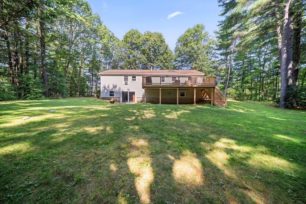 21 Woodman Road Amesbury, MA 01913 - Photo 22 of 30 a view of a house with a big yard and large trees