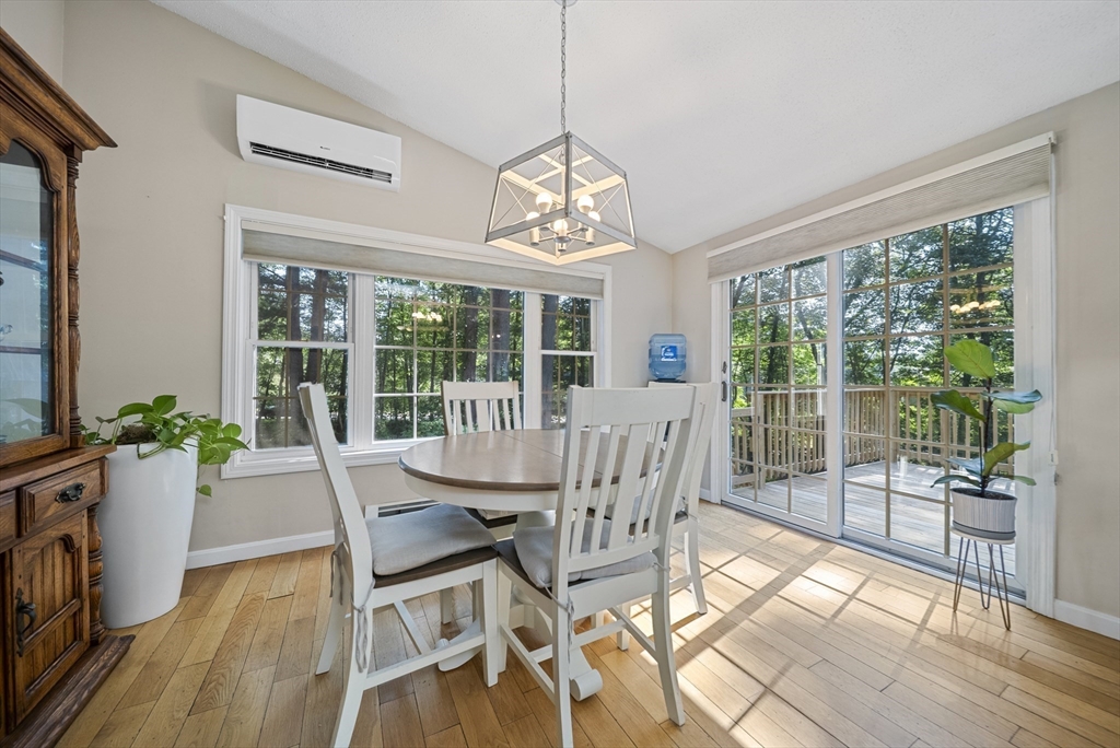 21 Woodman Road Amesbury, MA 01913 - Photo 3 of 30 a view of a dining room with furniture large windows and wooden floor