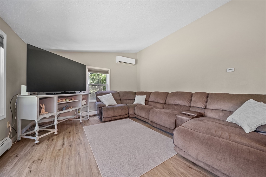 21 Woodman Road Amesbury, MA 01913 - Photo 8 of 30 a living room with furniture and a flat screen tv
