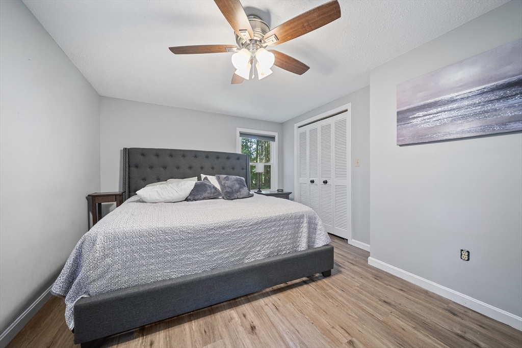 21 Woodman Road Amesbury, MA 01913 - Photo 10 of 30 a bedroom with a bed and a ceiling fan