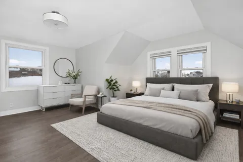 a bedroom with bed and a chandelier