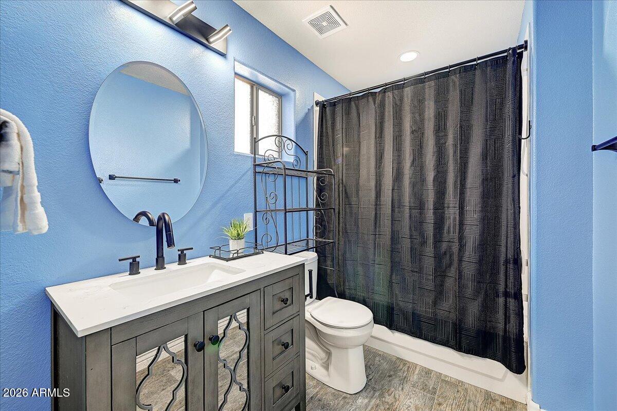 7624 North Citrus Road Waddell, AZ 85355 - Photo 32 of 57 a bathroom with a sink a toilet and shower