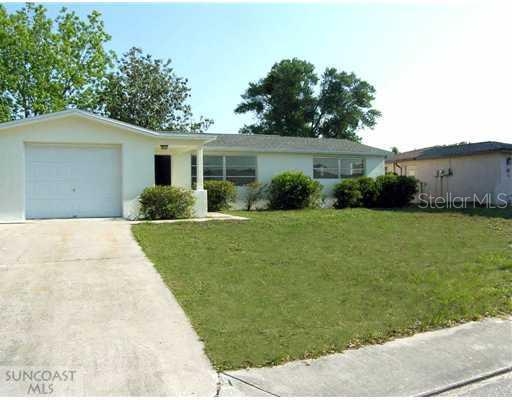 5613 Chipper Drive New Port Richey, FL 34652 - Photo 1 of 1 a front view of a house with garden