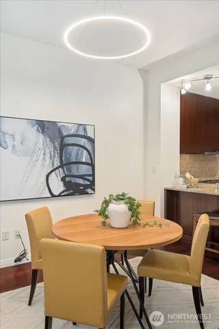a dining room with furniture and wooden floor