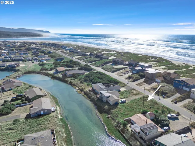 an aerial view of a city with ocean view in back