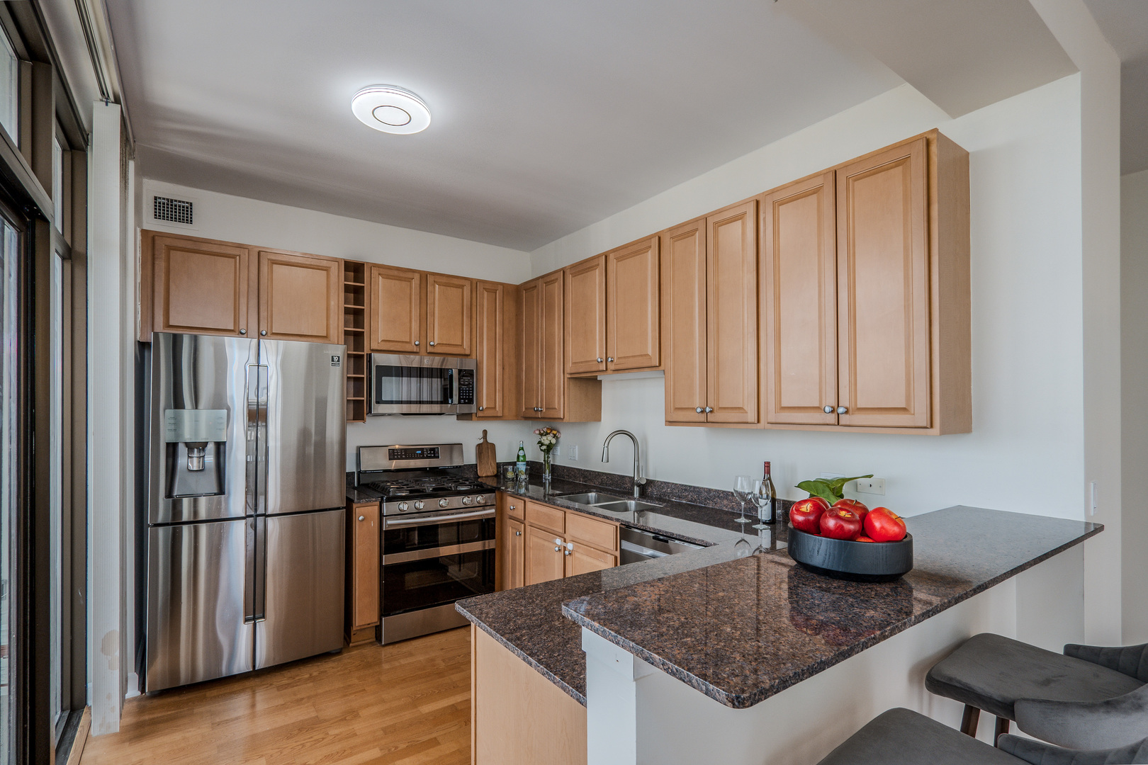 233 East 13th Street, Unit 2001 Chicago, IL 60605 - Photo 13 of 48 a kitchen with stainless steel appliances granite countertop a refrigerator sink and cabinets