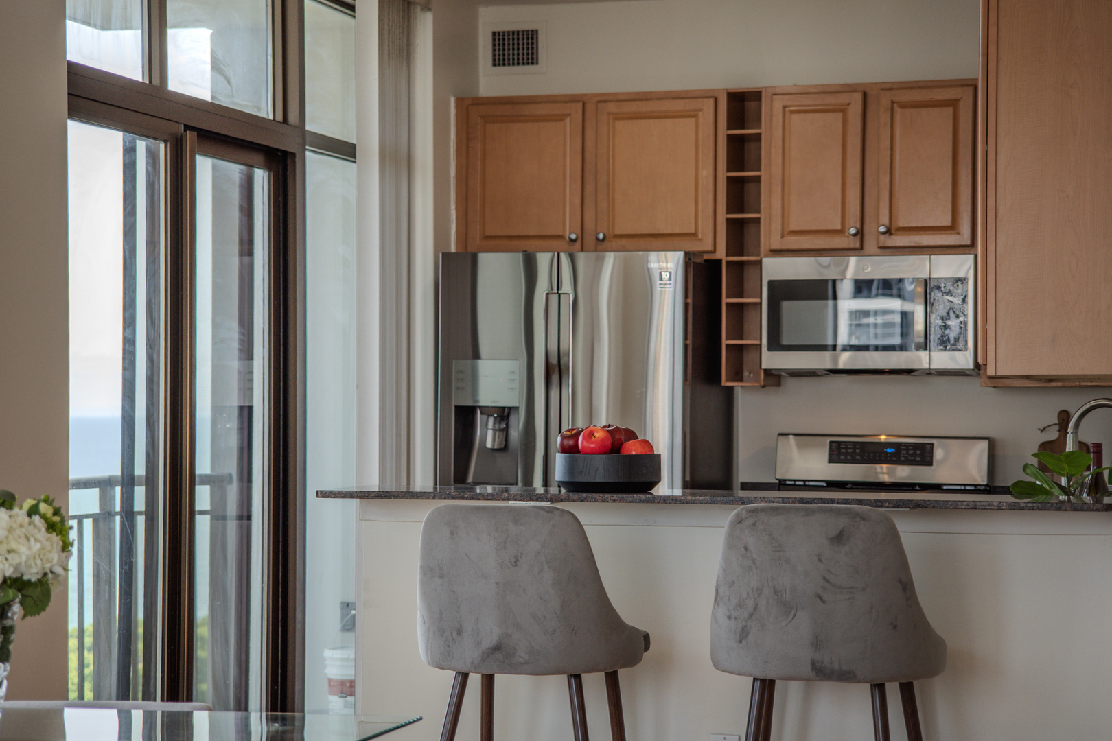 233 East 13th Street, Unit 2001 Chicago, IL 60605 - Photo 16 of 48 a kitchen with a window and a chair