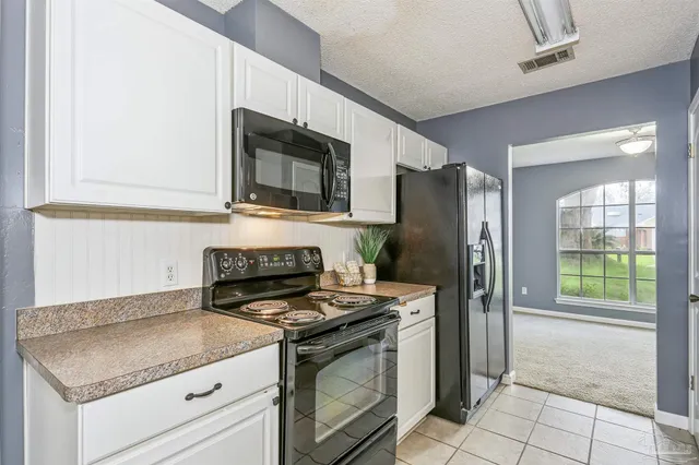 a kitchen with a stove microwave and refrigerator