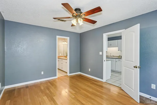 a bedroom with a bed and a ceiling fan