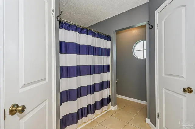 a view of bathroom with a shower and a mirror