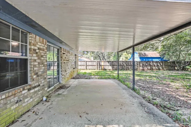 a view of a house with backyard and a tree
