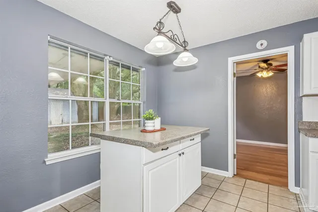 a kitchen with a counter space cabinets and a window
