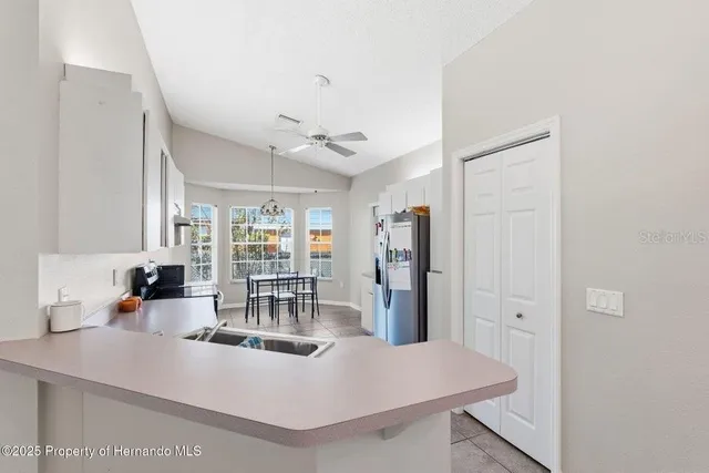 a view of kitchen island with stainless steel appliances