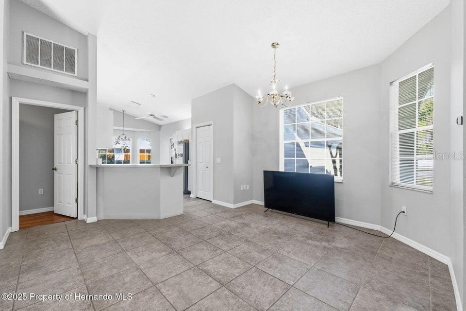 10290 Adler Street Spring Hill, FL 34608 - Photo 15 of 34 a view of a kitchen with furniture and wooden floor