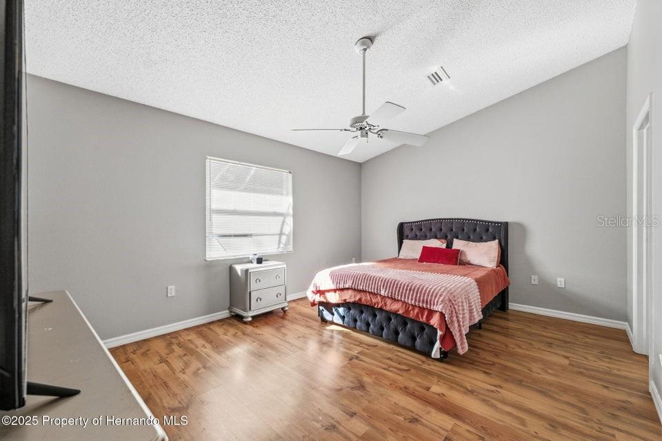 10290 Adler Street Spring Hill, FL 34608 - Photo 17 of 34 a bedroom with a bed and window