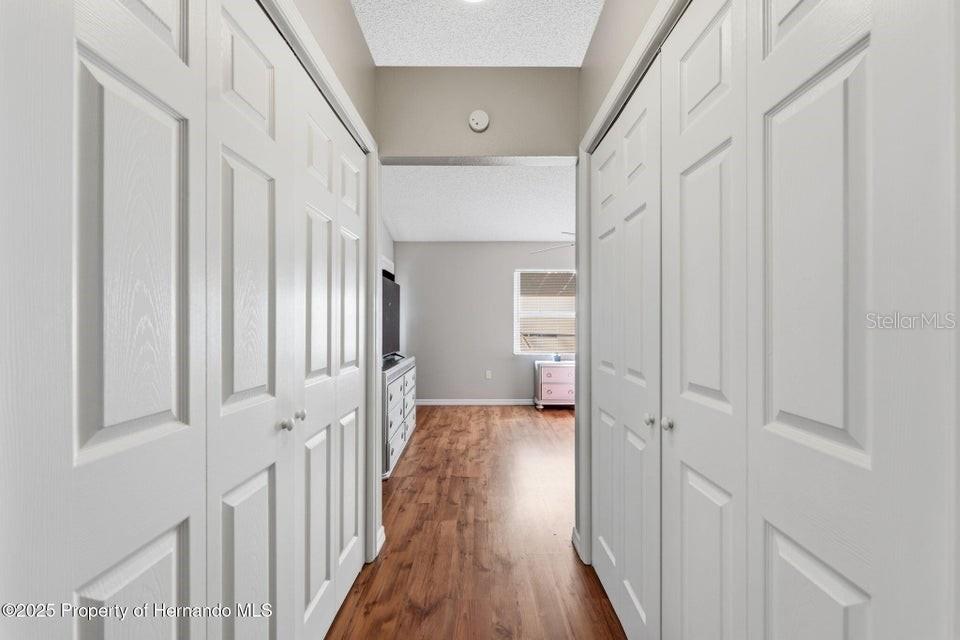10290 Adler Street Spring Hill, FL 34608 - Photo 18 of 34 a view of a hallway with a wooden door