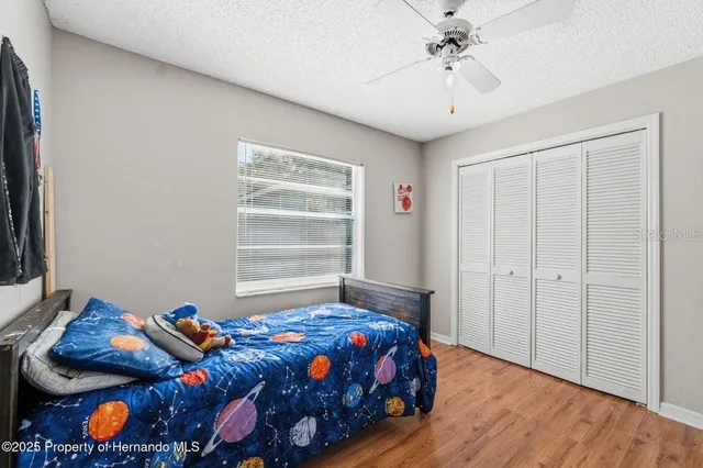 a bedroom with bed and a window