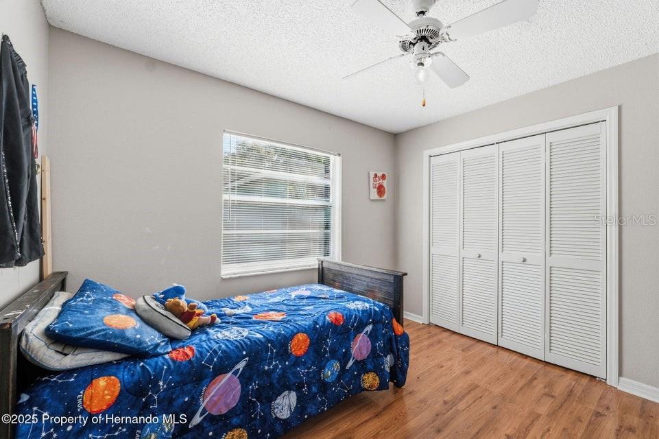 10290 Adler Street Spring Hill, FL 34608 - Photo 22 of 34 a bedroom with bed and a window