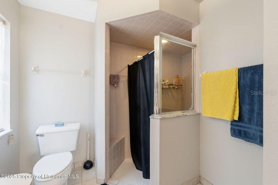 10290 Adler Street Spring Hill, FL 34608 - Photo 28 of 34 a bathroom with a toilet and a shower