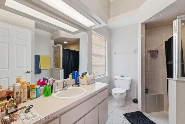 a bathroom with a sink vanity mirror and toilet