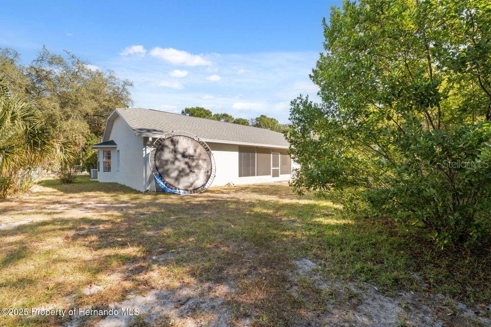 10290 Adler Street Spring Hill, FL 34608 - Photo 32 of 34 a view of a house with a backyard