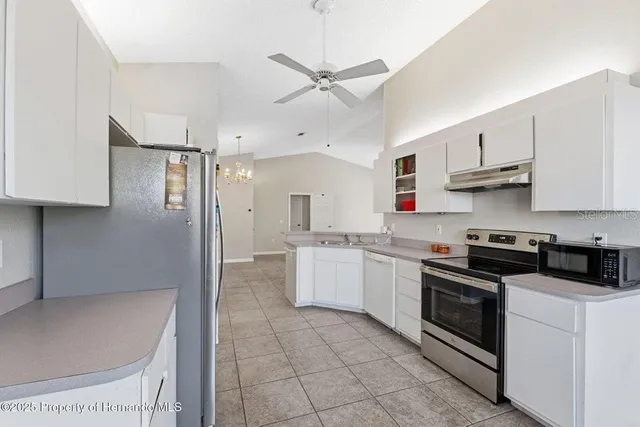a kitchen with a stove top oven and cabinets