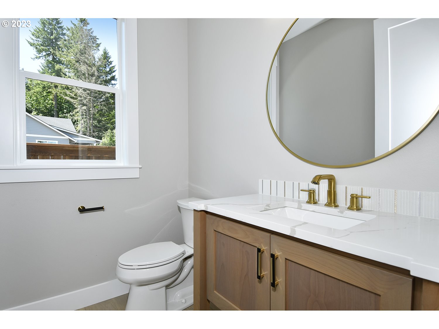 14915 Northeast 40th Street Vancouver, WA 98686 - Photo 13 of 17 a bathroom with a granite countertop toilet a sink a mirror and a window