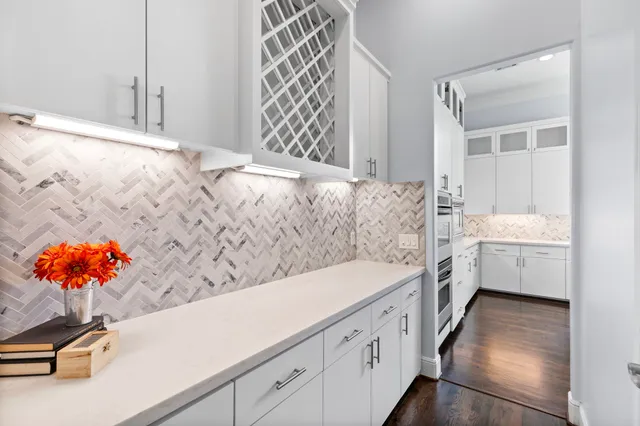 a bathroom with a sink mirror and a bathtub