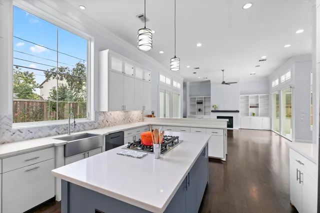 a large kitchen with kitchen island a sink appliances and a counter space