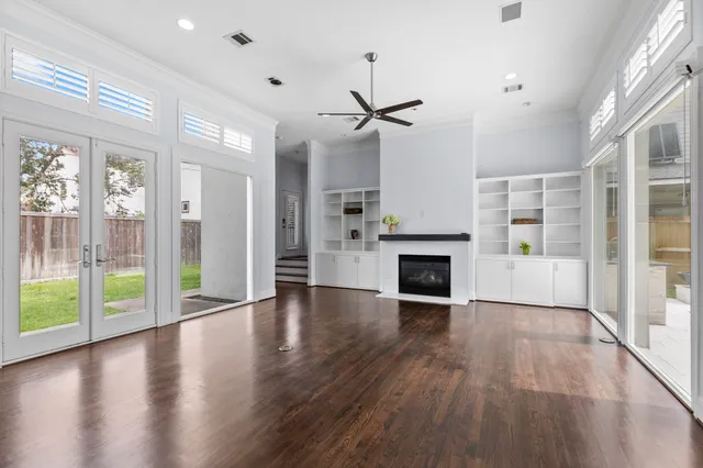 a view of a livingroom with wooden floor a fireplace and window