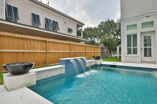 a view of a backyard with swimming pool
