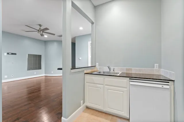 a view of cabinets a sink and dishwasher in a room