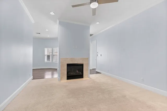 an empty room with a fireplace and fan