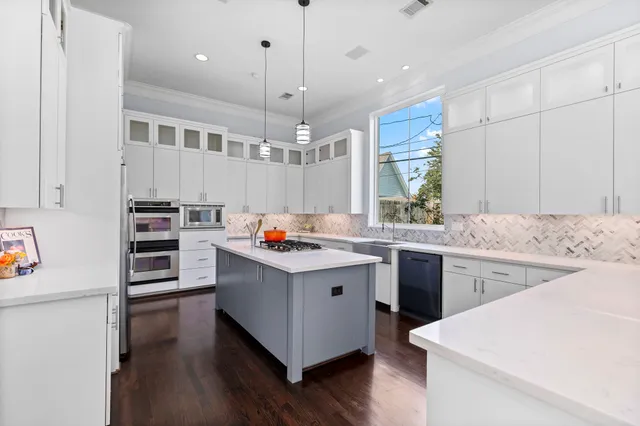a kitchen with a sink stove and cabinets
