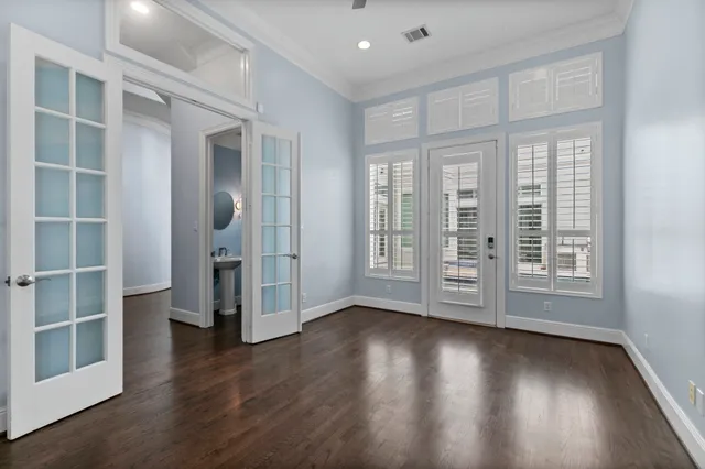a view of wooden floor and windows in a room