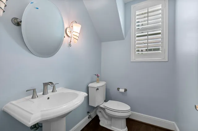 a bathroom with a sink a mirror and a toilet