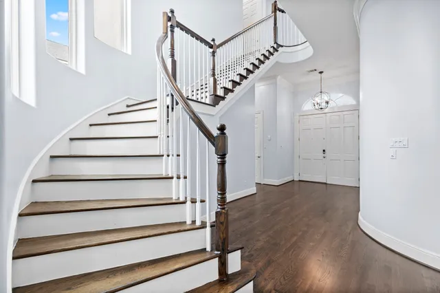 a view of entryway and hall with wooden floor