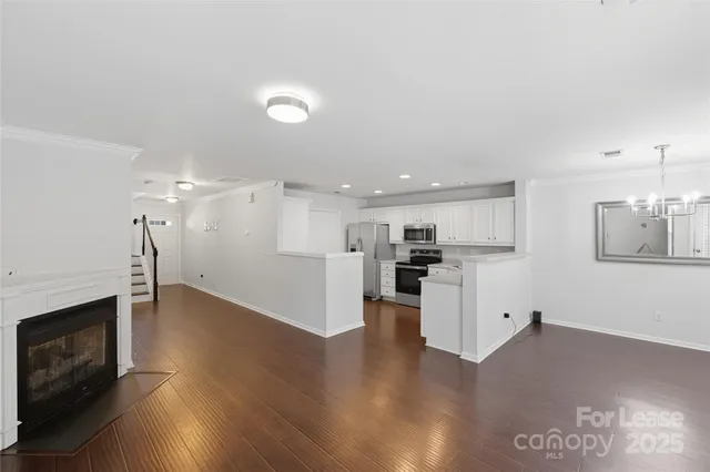 a view of kitchen with wooden floor and electronic appliances
